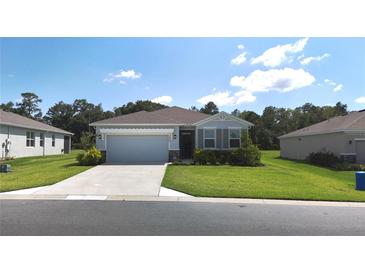 Charming one-story home featuring a two-car garage, well-maintained lawn, and inviting curb appeal at 6203 Sw 93Rd Loop, Ocala, FL 34476