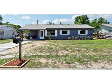Charming single-story home featuring a gray exterior, metal roof, and a well-maintained front yard at 1406 Hope Ct, Tavares, FL 32778