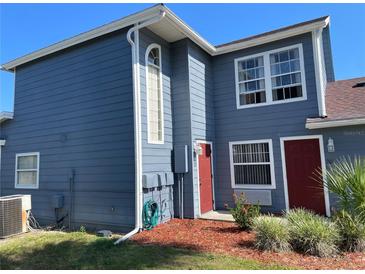 Two-story home featuring a freshly painted exterior and well-manicured landscaping at 206 Orchid Dr, Davenport, FL 33897