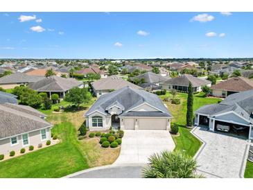 Expansive aerial view of a single-Gathering home with well-manicured lawn in a sunny neighborhood at 3405 Nursery Pl, The Villages, FL 32163