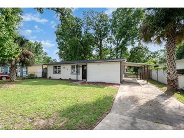 Charming single story home with a large front yard and a covered driveway, perfect for parking and protection from the elements at 121 Mason Park Dr, Daytona Beach, FL 32117