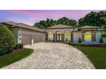 Beautiful single-Gathering home with well-manicured landscaping and an elegant circular driveway at 16951 Florence View Dr, Montverde, FL 34756