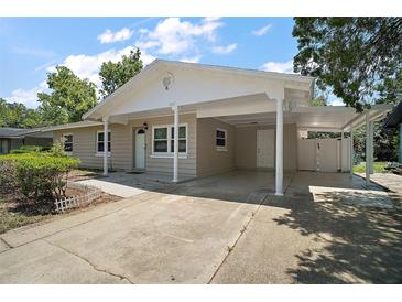 Charming single-story home featuring a covered carport and well-maintained landscaping at 1805 Jefferson Dr, Mount Dora, FL 32757