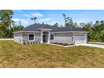 Attractive single-Gathering home with stone facade and well-maintained lawn at 24912 Jefferson St, Astatula, FL 34705