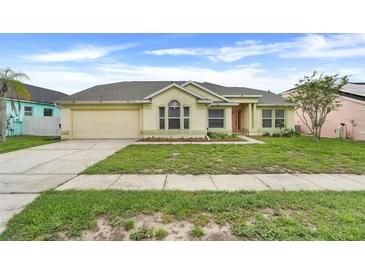 Charming single-story home featuring a well-maintained lawn and an attached two-car garage at 2896 Picadilly Cir, Kissimmee, FL 34747