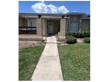 Charming single-story home with inviting entrance and manicured lawn at 3306 Sandy Shore Ln, Kissimmee, FL 34743