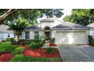Charming single-story home with well-maintained lawn, landscape beds, and attached two-car garage at 3718 Westerham Dr, Clermont, FL 34711