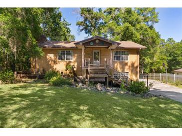 Charming brick home with a well-maintained lawn and inviting front porch, perfect for enjoying the outdoors at 5581 Sw 197Th Ter, Dunnellon, FL 34431