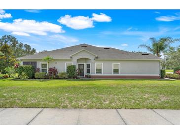 Beautiful single-story home with well-manicured lawn and lush landscaping at 3550 Fairwaters Ct # D, Clermont, FL 34711