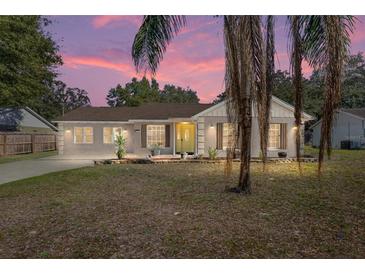 Charming home featuring desert landscaping and a quaint entrance, perfect for a serene lifestyle at 40140 Palm St, Lady Lake, FL 32159