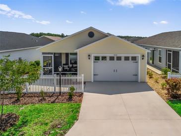 Charming single-story home featuring a two-car garage, screened porch, and well-maintained landscaping at 6301 Whittle Ct, The Villages, FL 32163