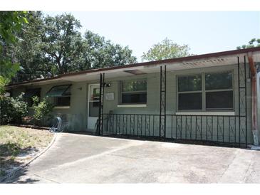 Exterior view of home featuring a covered porch, concrete driveway, and mature trees at 1095 Golden Isle Dr, Mount Dora, FL 32757