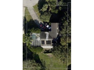 Aerial view of a single-Gathering home, featuring a screened pool, driveway with two cars, and a well-maintained lawn at 12730 Katherine Cir, Clermont, FL 34711