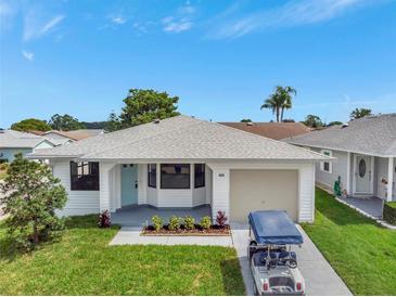 Charming single-story home featuring a well-maintained lawn and an attached one-car garage at 2235 Harbor Town Ln, Lakeland, FL 33810