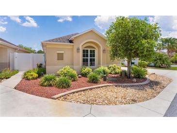 Charming single-story home featuring well-manicured landscaping and a welcoming entrance at 2967 Thayer Ter, The Villages, FL 32163
