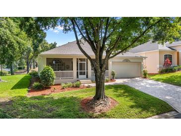 Charming single-story home with a screened porch, attached garage and a landscaped front yard and brick-paved drive at 3607 Fairfield Dr, Clermont, FL 34711