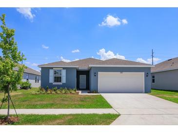 Charming single-story home with a well-manicured lawn and a two-car garage at 520 Silver Palm Dr, Haines City, FL 33844