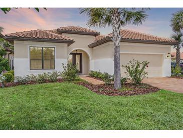Charming single-story home boasts a tile roof, manicured lawn, and lush landscaping at 9220 San Jose Blvd, Howey In The Hills, FL 34737