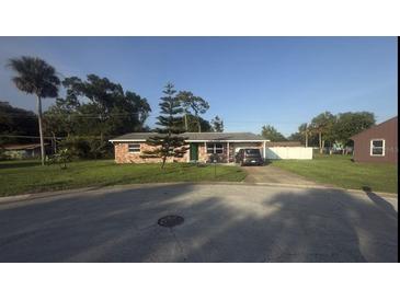 Charming single-story brick home with a well-maintained lawn and mature landscaping at 48 Pinehurst Cir, Ormond Beach, FL 32174