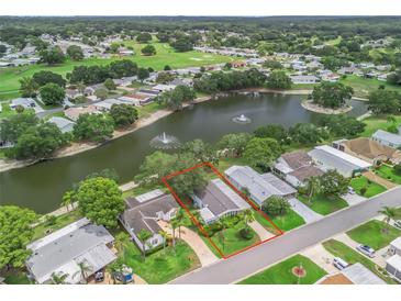 Beautiful home with lake view, mature trees, fountain and golf course in distance at 727 Turnberry Ln, The Villages, FL 32159