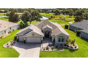 Beautiful single-story home featuring manicured landscaping and a desirable golf course view at 9059 Se 177Th Grassmere St, The Villages, FL 32162