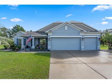 Charming one-story home with a well-manicured lawn, two-car garage, and inviting front porch at 1640 Marsh Pointe Dr, Clermont, FL 34711
