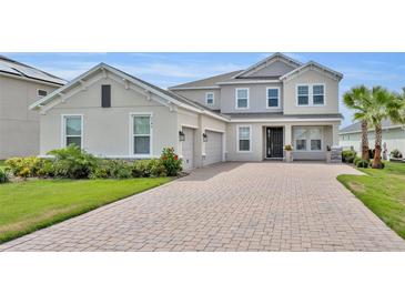 Stunning two-story home with brick driveway, attached two-car garage and meticulously maintained landscaping at 2147 Timber Creek Ln, Clermont, FL 34715