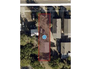 An aerial view shows the property lot and surrounding neighborhood with mature trees at 220 E Woodward Ave, Eustis, FL 32726