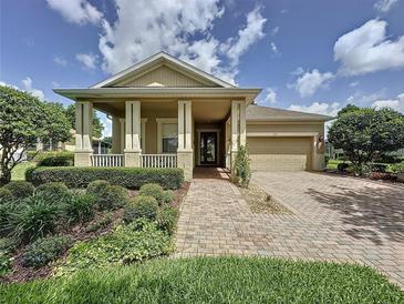 Charming single-Gathering home featuring a well-manicured lawn and a welcoming brick pathway to the front door at 243 Bayou Bend Rd, Groveland, FL 34736