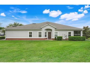 This backyard features a well-manicured lawn and neatly trimmed hedges surrounding the house at 3547 Fairwaters Ct # F, Clermont, FL 34711