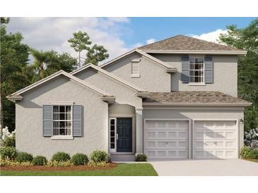 Charming two-story home with a two-car garage, beautiful landscaping, and gray siding at 5035 Firebush Dr, Apopka, FL 32712