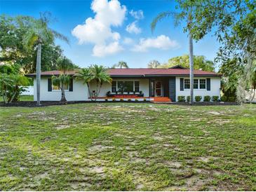 Charming single-story home featuring mature landscaping, bright exterior paint, and updated architectural details at 9269 Silver Lake Dr, Leesburg, FL 34788