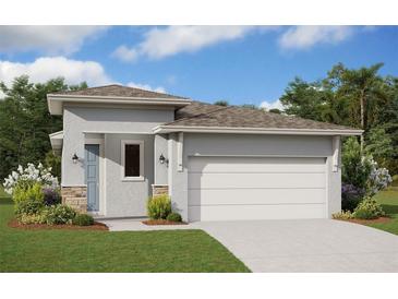 Charming single-story home with a two-car garage and neutral stucco finish accented with stone cladding at 2188 Sunshine Peak Dr, Minneola, FL 34715