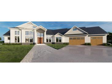 Stunning two-story home with large windows, a three-car garage, and a professionally landscaped yard at 2421 Shady Ln, Groveland, FL 34736