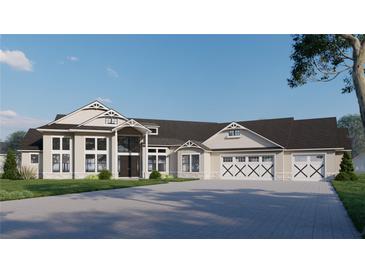 An elegant home features a spacious driveway, large windows, and a three-car garage with unique cross beam garage doors at 2421 Shady Ln, Groveland, FL 34736