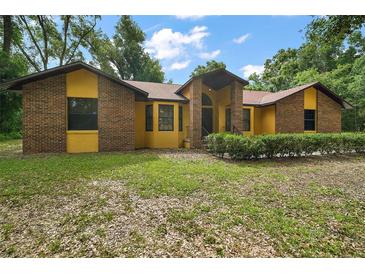 Charming single-story home with a well-maintained front yard and brick and siding accents at 37236 Cherry Lake Rd, Fruitland Park, FL 34731
