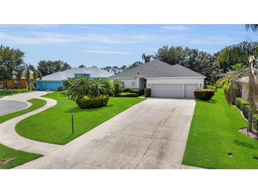 Well-maintained home featuring a lush green lawn, manicured landscaping and a concrete driveway leading to a three-car garage at 3819 Saint Emma Ct, Leesburg, FL 34748