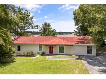 Charming home with a red-tile roof and a beautiful waterfront view at 6665 Lake Cane Dr, Orlando, FL 32819