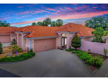 Charming one-story home featuring a red tile roof, spacious driveway, and well-maintained landscaping at 903 Santa Anna Ln, Lady Lake, FL 32159