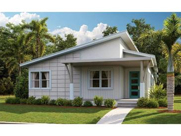 Charming single-story home featuring a covered porch, a blue front door, and tropical landscaping at 9878 Peebles St, Orlando, FL 32827