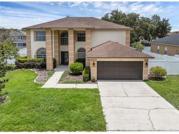 Stunning two-story home with a well-manicured lawn and a two-car garage at 1109 Needlewood Loop, Oviedo, FL 32765