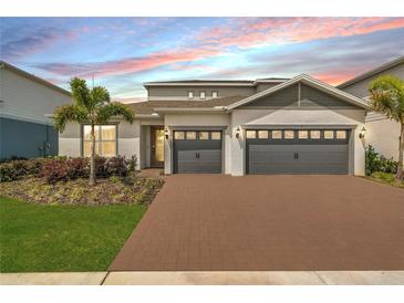 Charming one-story home featuring a two-car garage, brick driveway, and well-maintained landscaping at 15954 Winding Bluff Dr, Montverde, FL 34756
