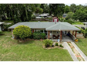 Charming single-story home with a covered carport, mature landscaping, and a well-maintained front lawn at 2202 Butler St, Leesburg, FL 34748