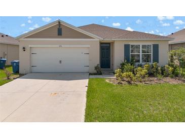 Charming single-story home with a two-car garage and well-maintained landscaping at 424 Noble Ave, Davenport, FL 33837