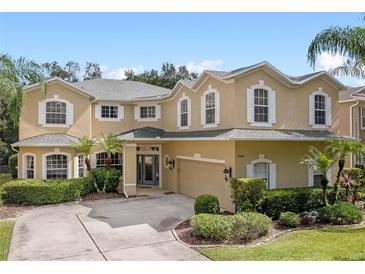 Beautiful two-story home with lush landscaping, manicured lawn, and a well-maintained driveway at 5144 Rishley Run Way, Mount Dora, FL 32757