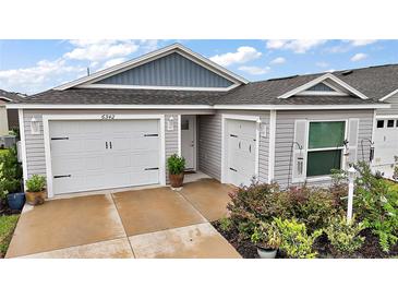 Charming single-story home with two-car garage and manicured landscaping enhancing the curb appeal at 6342 Whittle Ct, The Villages, FL 32163