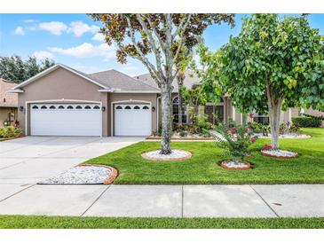 Charming home with a three car garage and landscaped front yard with beautiful trees at 965 Dartmouth Ave, Clermont, FL 34711