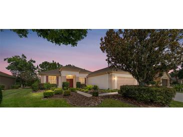 Beautiful single story home with a well-manicured lawn and mature landscaping in a desirable community at 12947 Se 97Th Terrace Rd, Summerfield, FL 34491