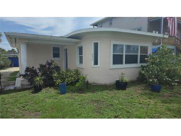 Charming single-story home featuring a stucco exterior, well-kept landscaping, and bright windows at 498 Golf Blvd, Daytona Beach, FL 32118