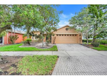 Charming single-Gathering home with a two car garage, brick paver driveway and meticulous landscaping at 645 Highlands Hammock Dr, Kissimmee, FL 34759